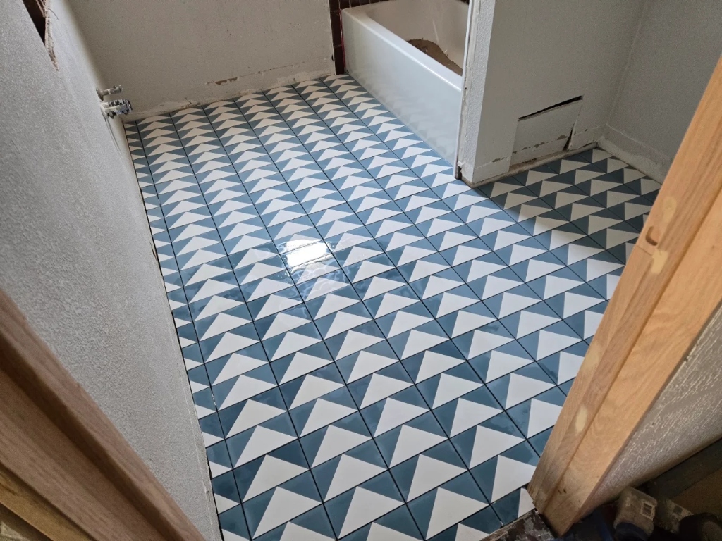 Blue and white geometric triangle bathroom floor installation