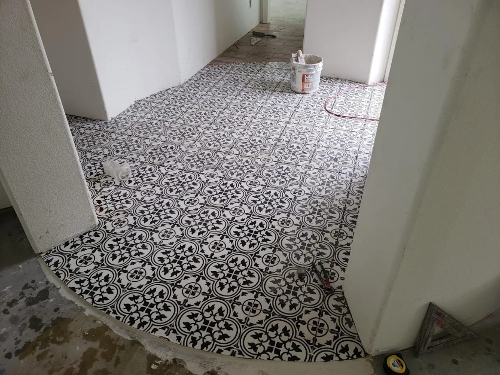 Black and white vintage patterned tile floor installation