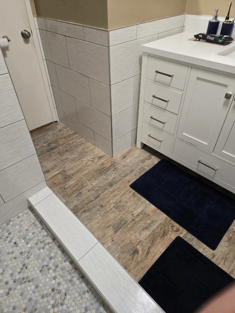 Wood-look bathroom floor tiling and tile walls