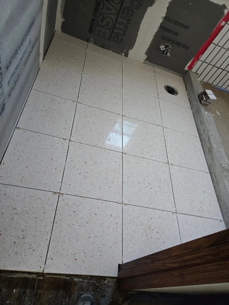Bathroom tiling under construction with clean white tiles